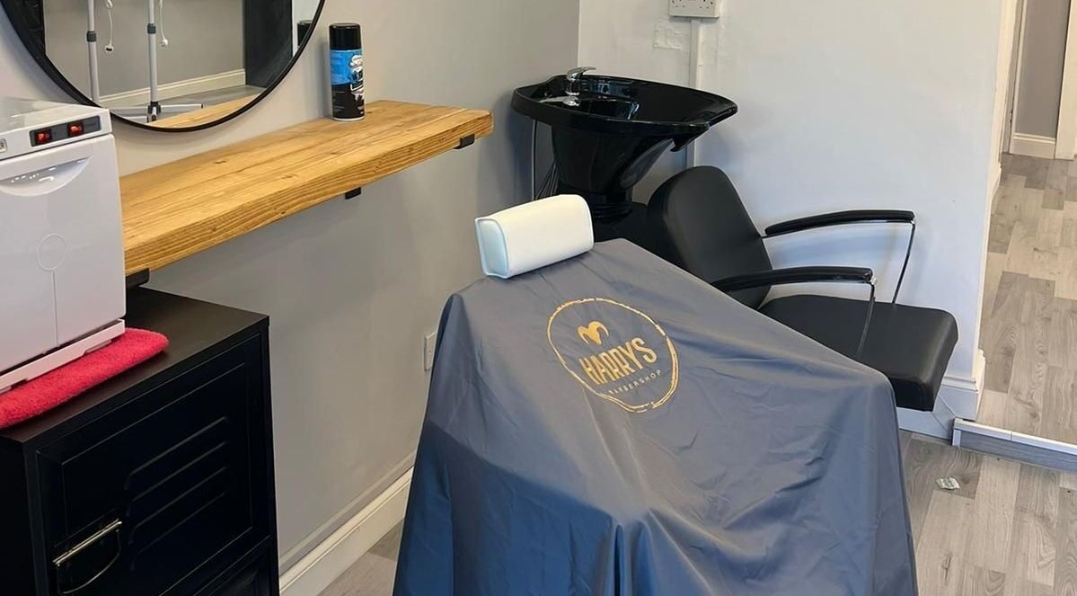 Modern chair setup at Harry’s Barbershop, Ramsbottom, England, GB, showcasing professional styling space.