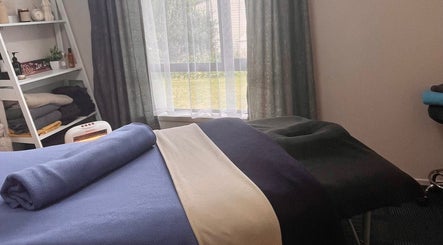 Calm treatment room at Body and Soul Holistic Wellbeing in Mokau, Waikato, NZ, featuring massage bed.