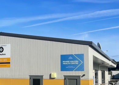 Exterior view of Body and Soul Holistic Wellbeing in Mokau, Waikato, NZ under a clear blue sky.