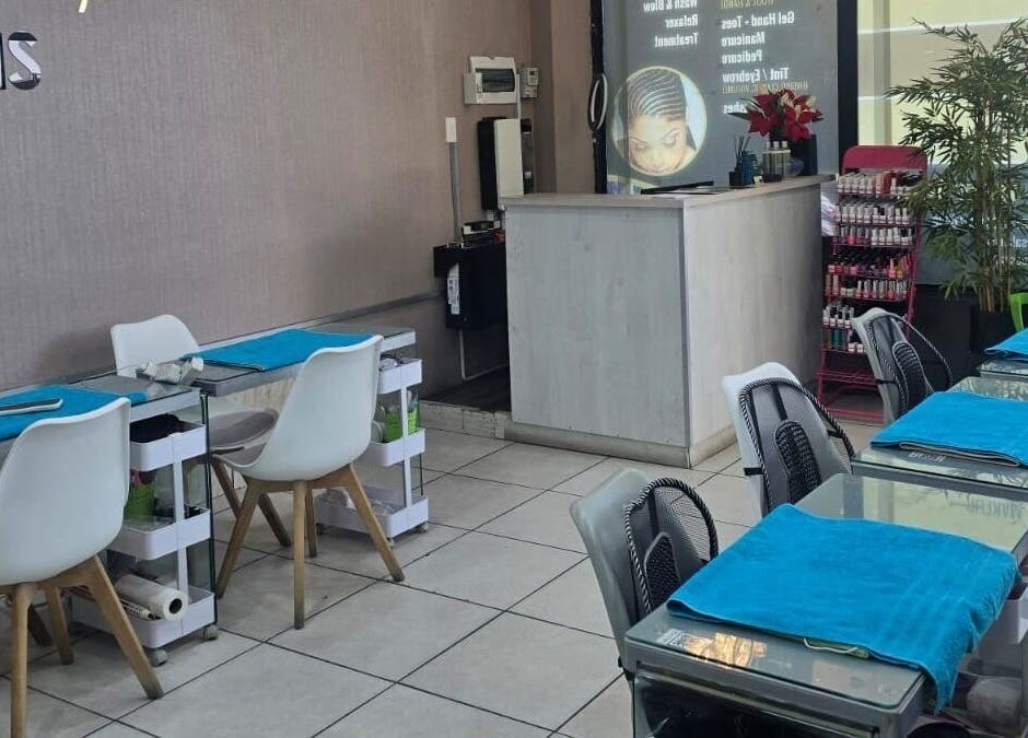 Stylish interior of Epiphany Salons SA in Randburg, Gauteng, ZA, featuring modern manicure stations and decor.