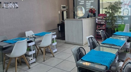 Stylish interior of Epiphany Salons SA in Randburg, Gauteng, ZA, featuring modern manicure stations and decor.