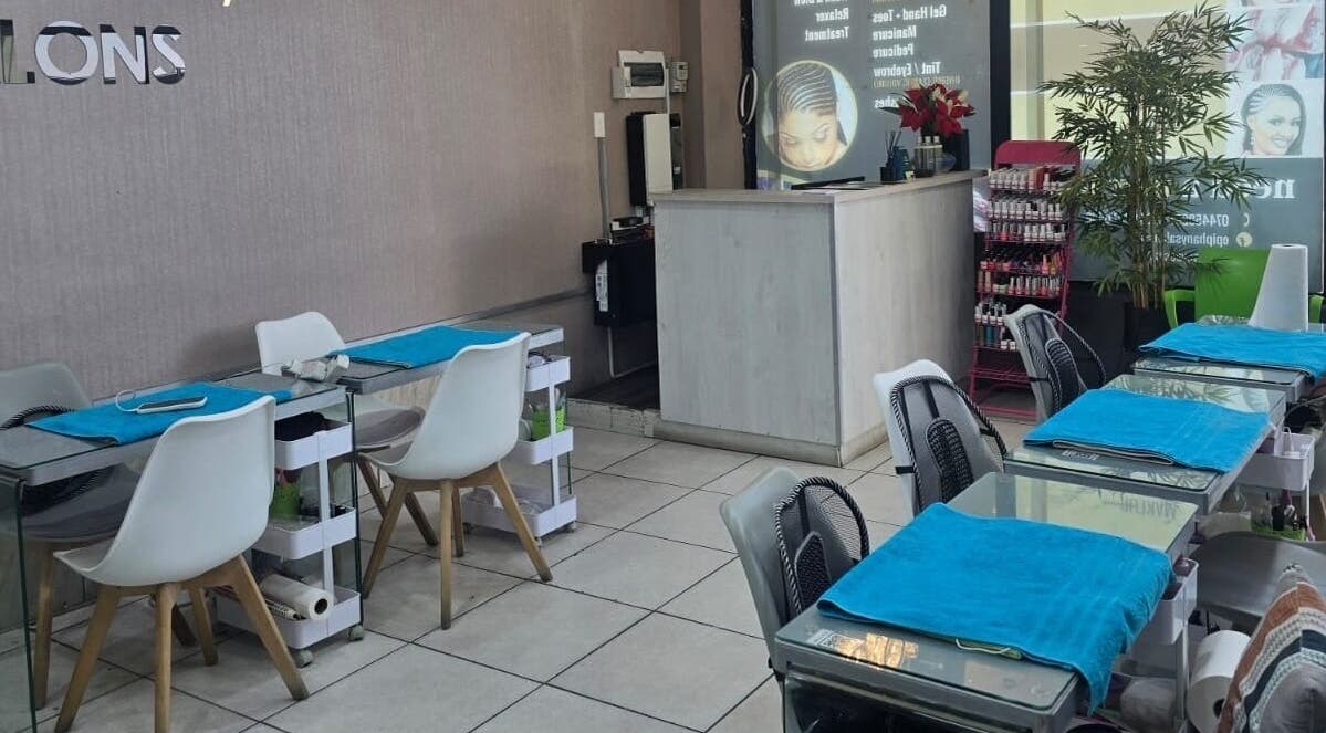 Stylish interior of Epiphany Salons SA in Randburg, Gauteng, ZA, featuring modern manicure stations and decor.