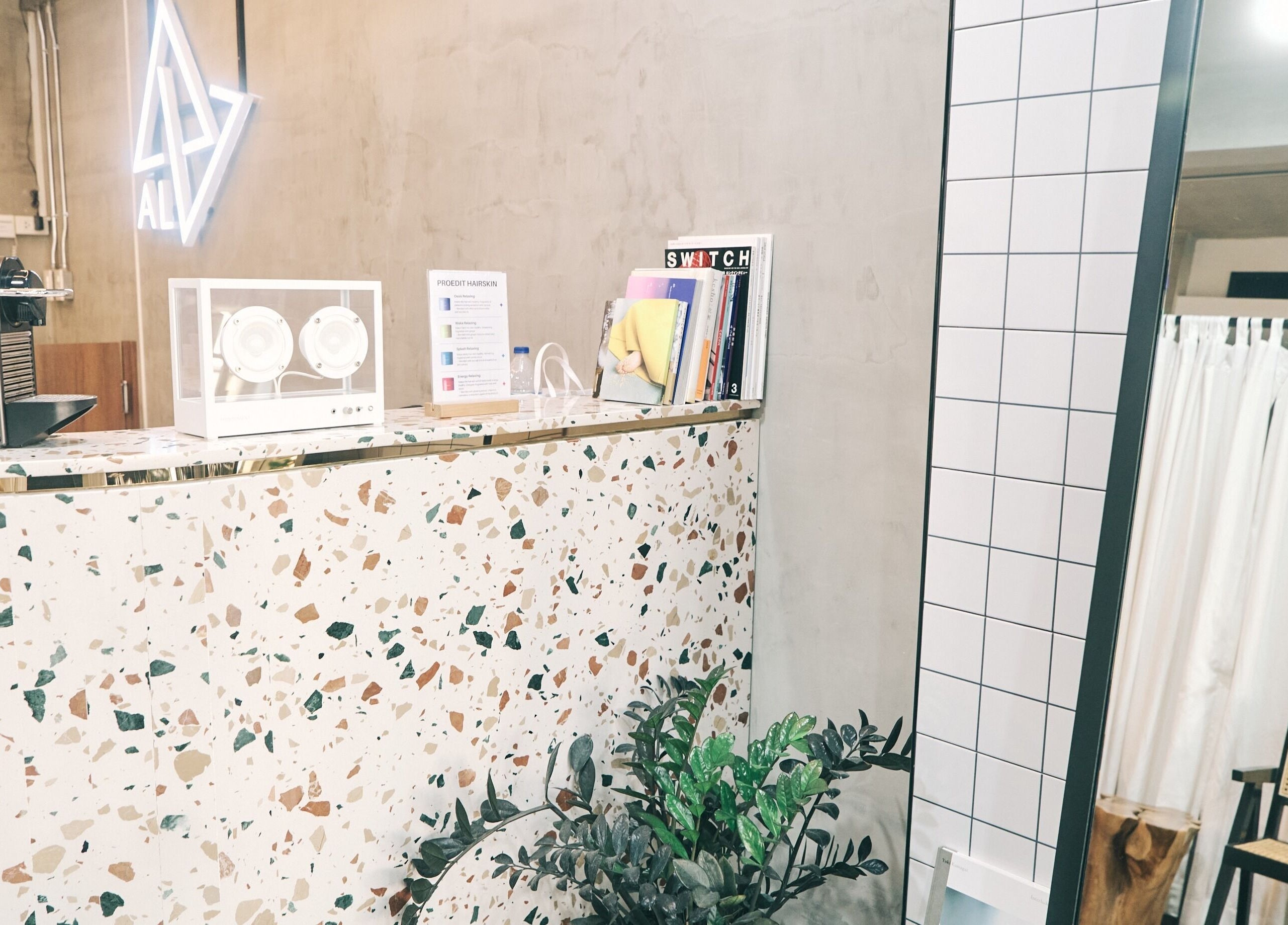 Modern reception area at AL etro, กรุงเทพมหานคร, TH with terrazzo counter and ambient lighting.