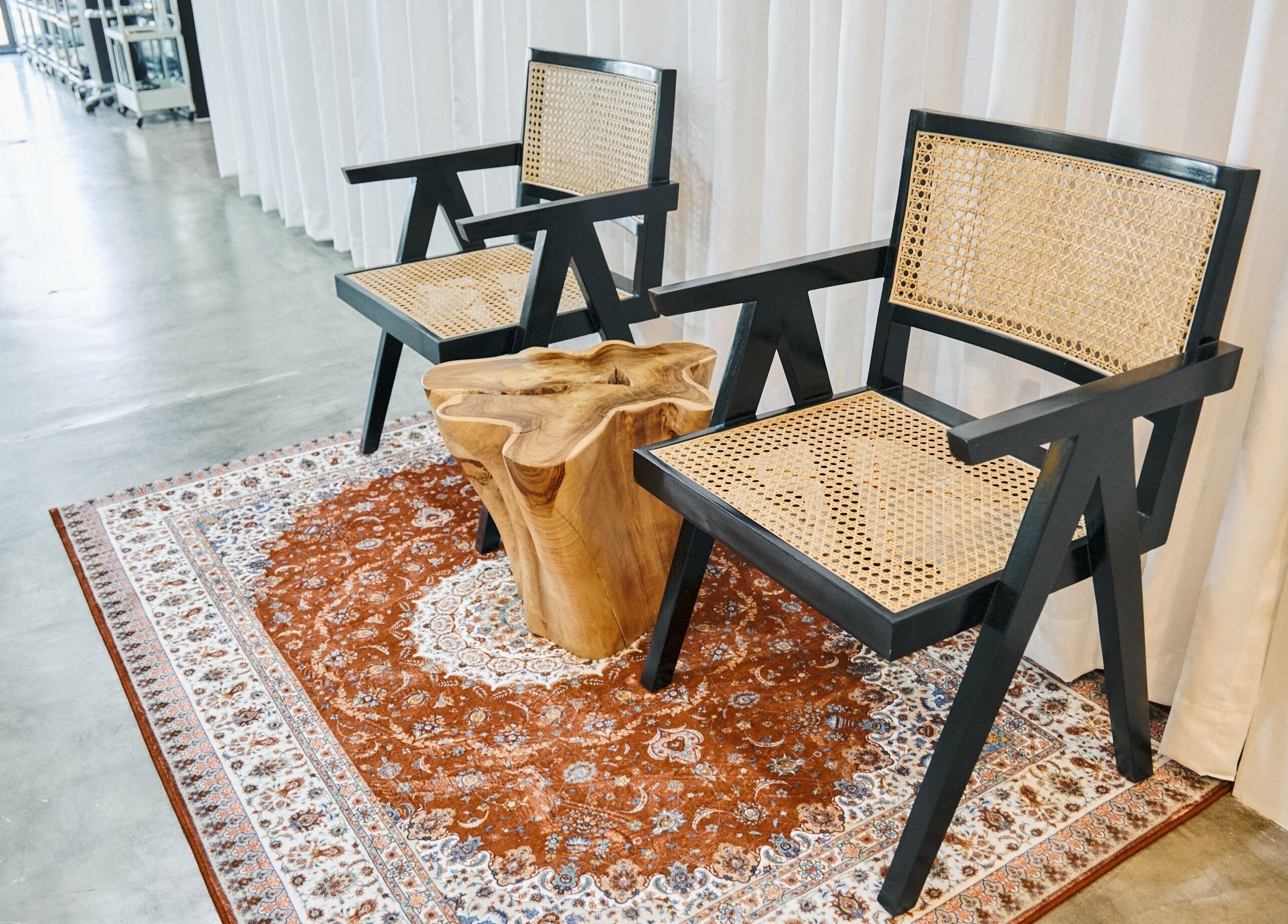 Cozy seating at AL etro in กรุงเทพมหานคร, TH with designer chairs and a rustic wooden table.