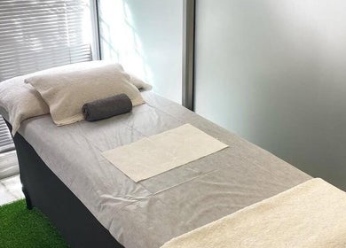 Relaxing treatment room at Mystique Aesthetics Century City, Cape Town, Western Cape, ZA with a comfortable massage bed.