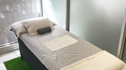 Relaxing treatment room at Mystique Aesthetics Century City, Cape Town, Western Cape, ZA with a comfortable massage bed.