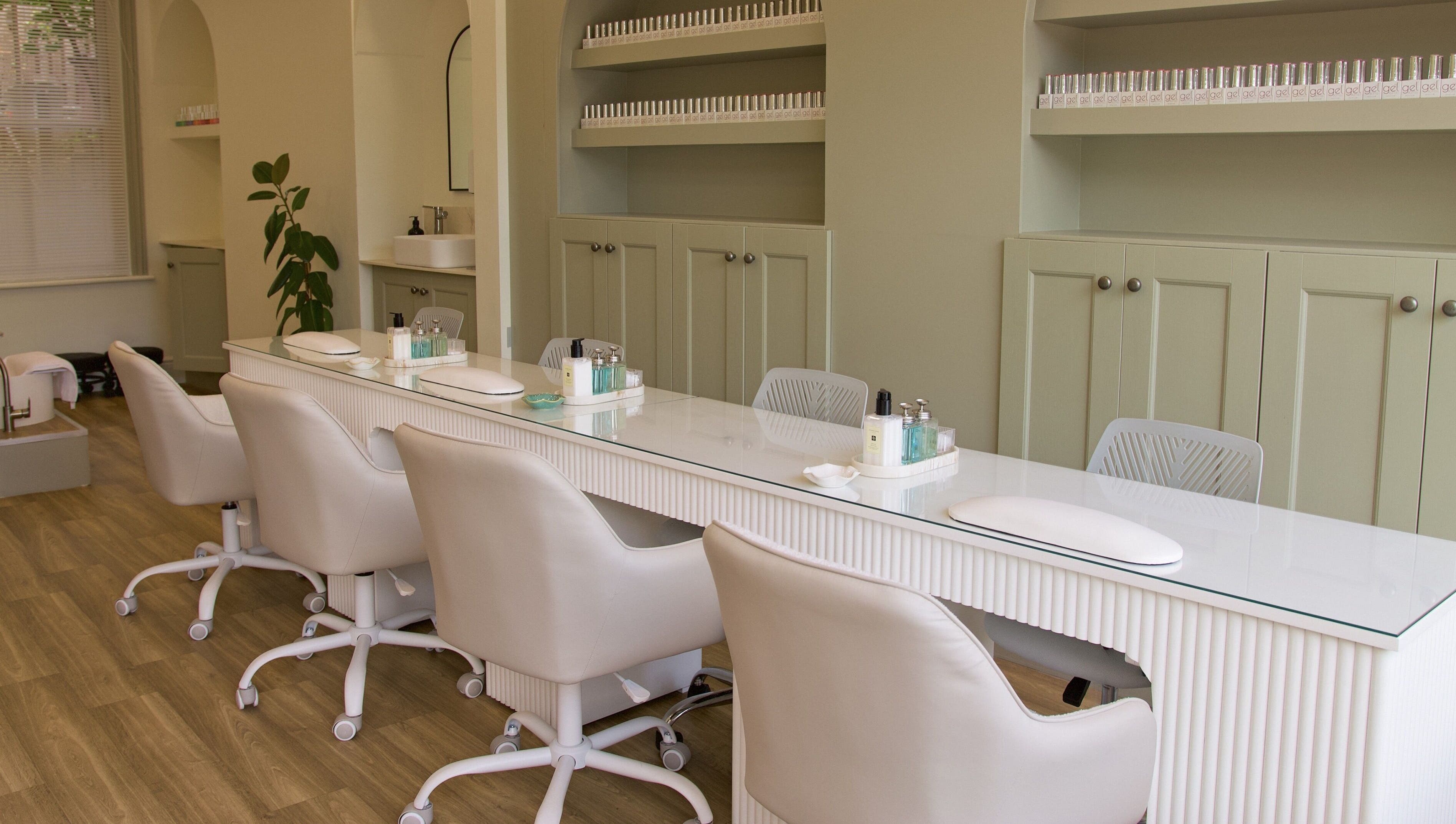 Modern nail salon The NailpodTw in Royal Tunbridge Wells, England, GB with chic seating at a polished manicure bar.