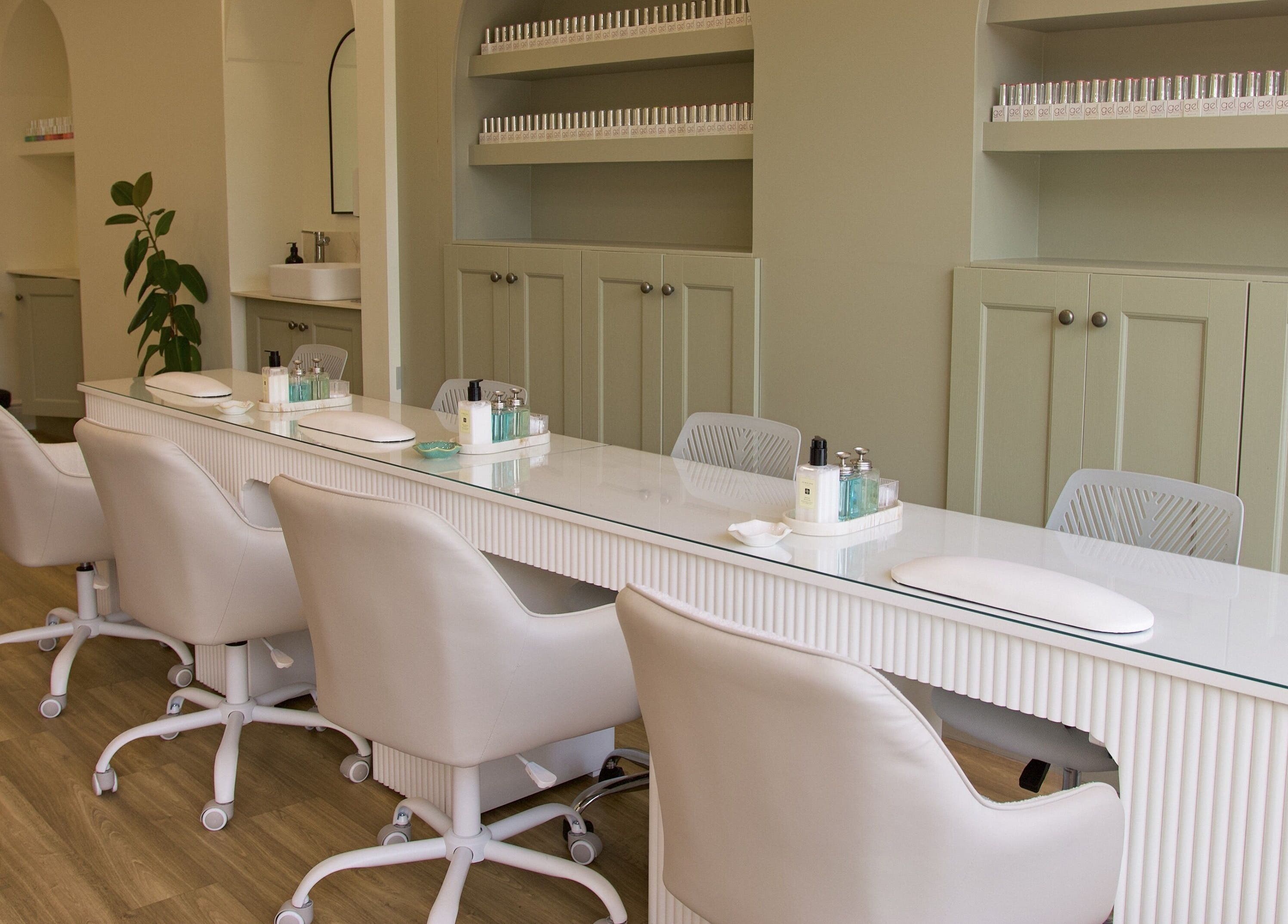 Modern nail salon The NailpodTw in Royal Tunbridge Wells, England, GB with chic seating at a polished manicure bar.