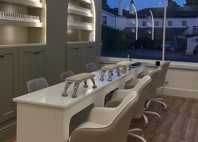 Elegant nail station setup at The NailpodTw, Royal Tunbridge Wells, England, GB with modern chairs and decor.