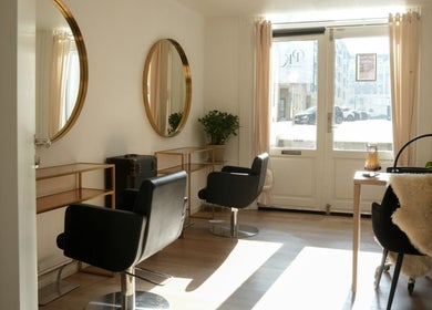 Stylish interior of Hair By Penny Kotsi in København, Denmark, DK with modern chairs and mirrors.