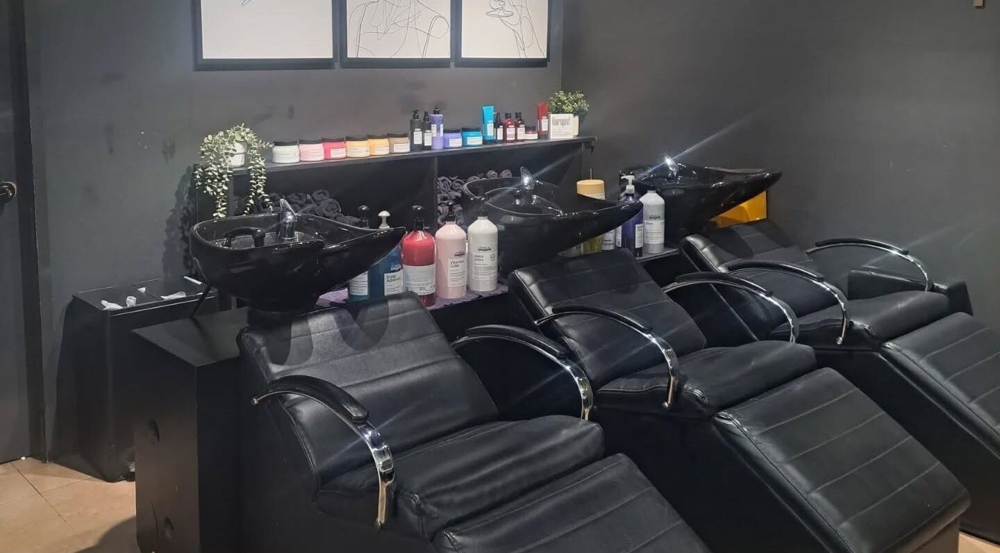 Modern shampoo stations at The Bar / Knockout Hair and Beauty in Penrith, New South Wales, AU, with elegant seating.