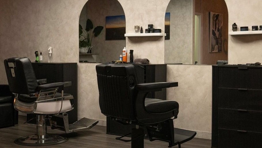Elegant interior of District Barber Studio in Samford Village, Queensland, AU, featuring sleek barber chairs.