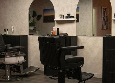 Elegant interior of District Barber Studio in Samford Village, Queensland, AU, featuring sleek barber chairs.