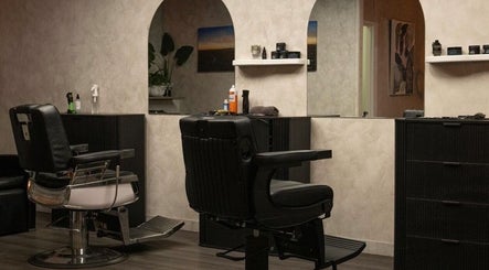 Elegant interior of District Barber Studio in Samford Village, Queensland, AU, featuring sleek barber chairs.