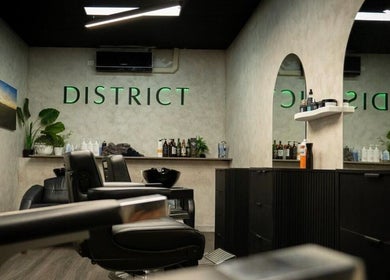 Interior of District Barber Studio in Samford Village, Queensland, AU, featuring stylish seating and modern decor.