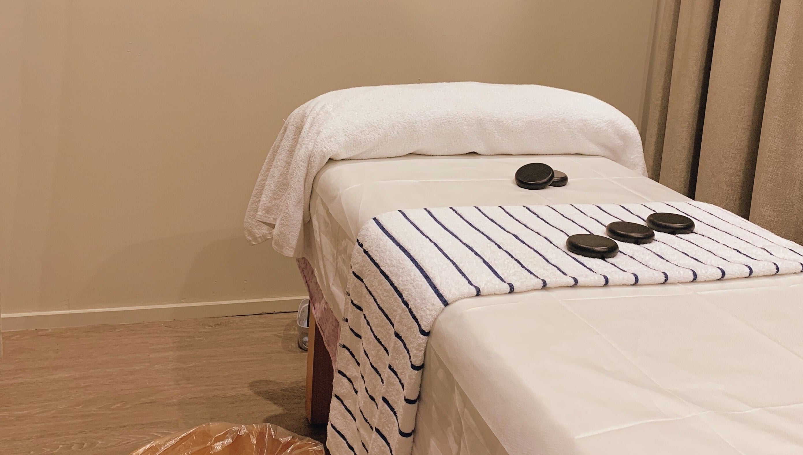 Calming massage table setup at A1 Massage in Joondalup, Western Australia, AU with hot stones and towels.