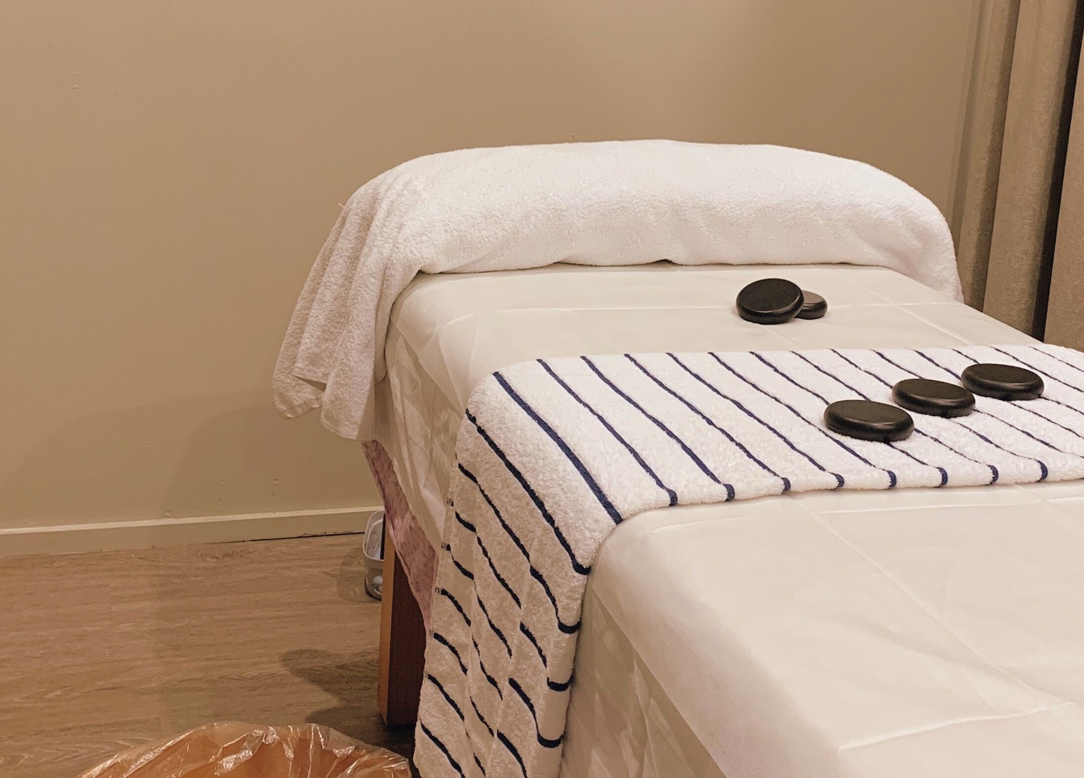 Calming massage table setup at A1 Massage in Joondalup, Western Australia, AU with hot stones and towels.