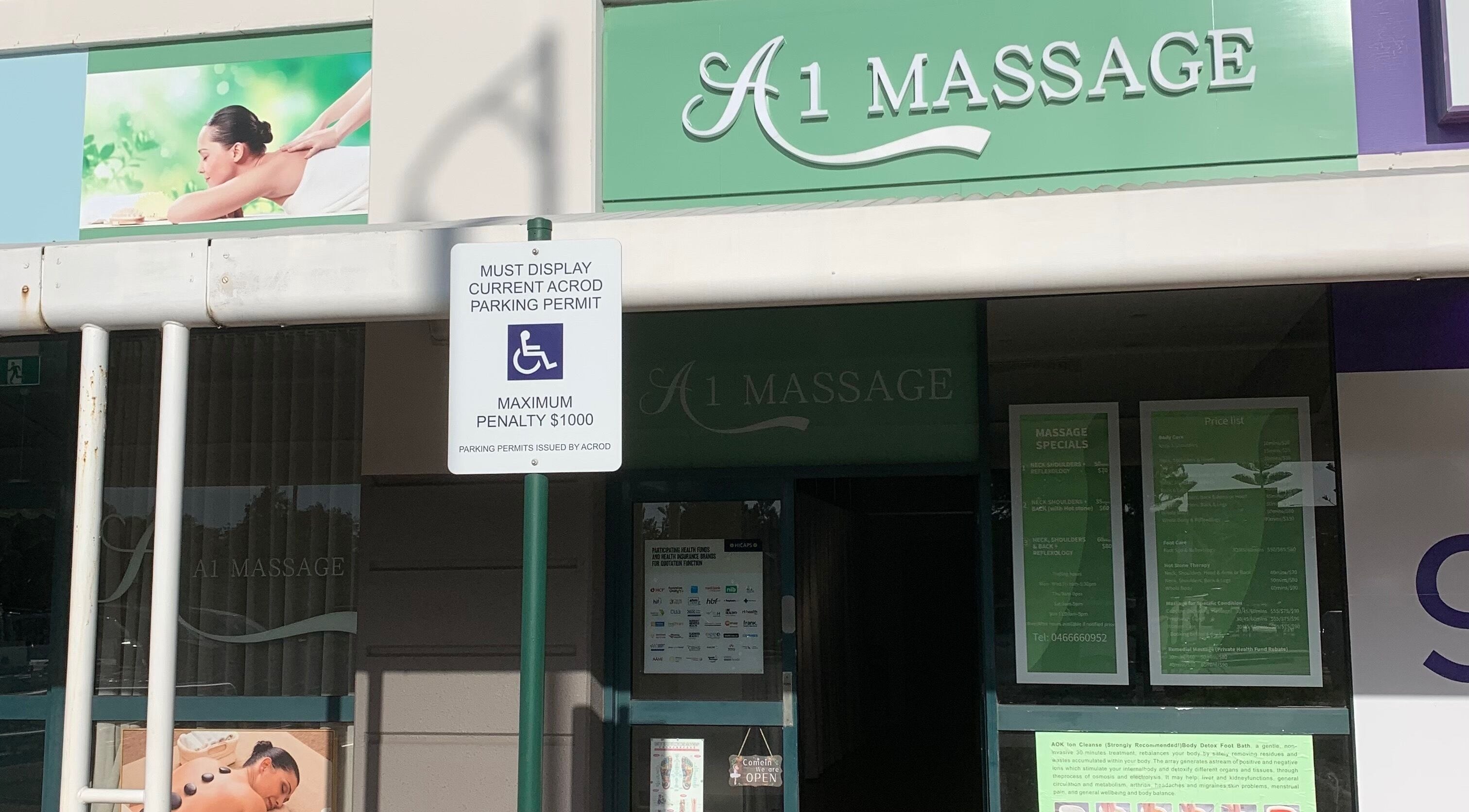 Front of A1 Massage, Joondalup, Western Australia, AU showcasing entry with wellness posters.