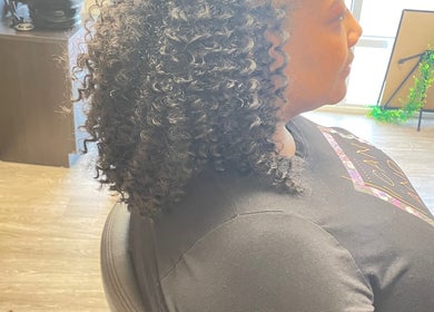 Curly hairstyle in Studio 23 Luxe at Cranbury, New Jersey, US showcasing relaxed salon ambiance.