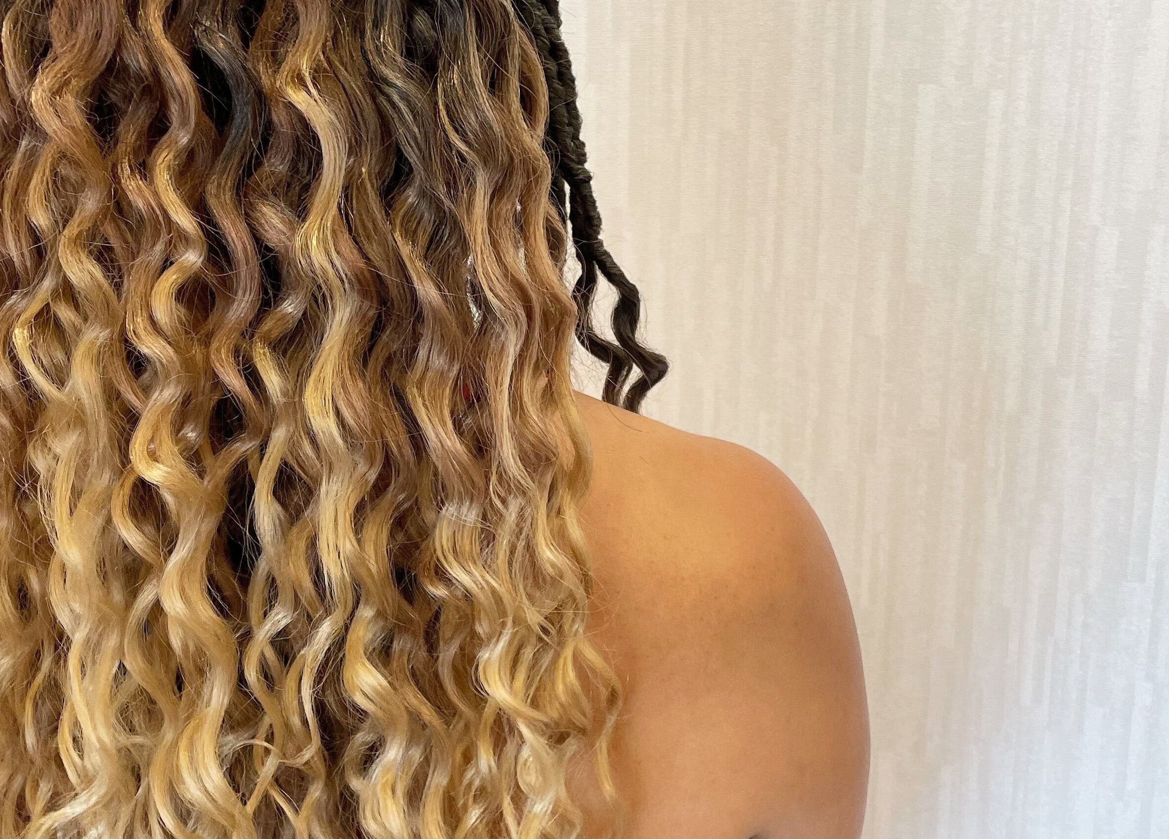 Curly hair transformation at Studio 23 Luxe in Cranbury, New Jersey, US, highlighting soft golden waves and texture.