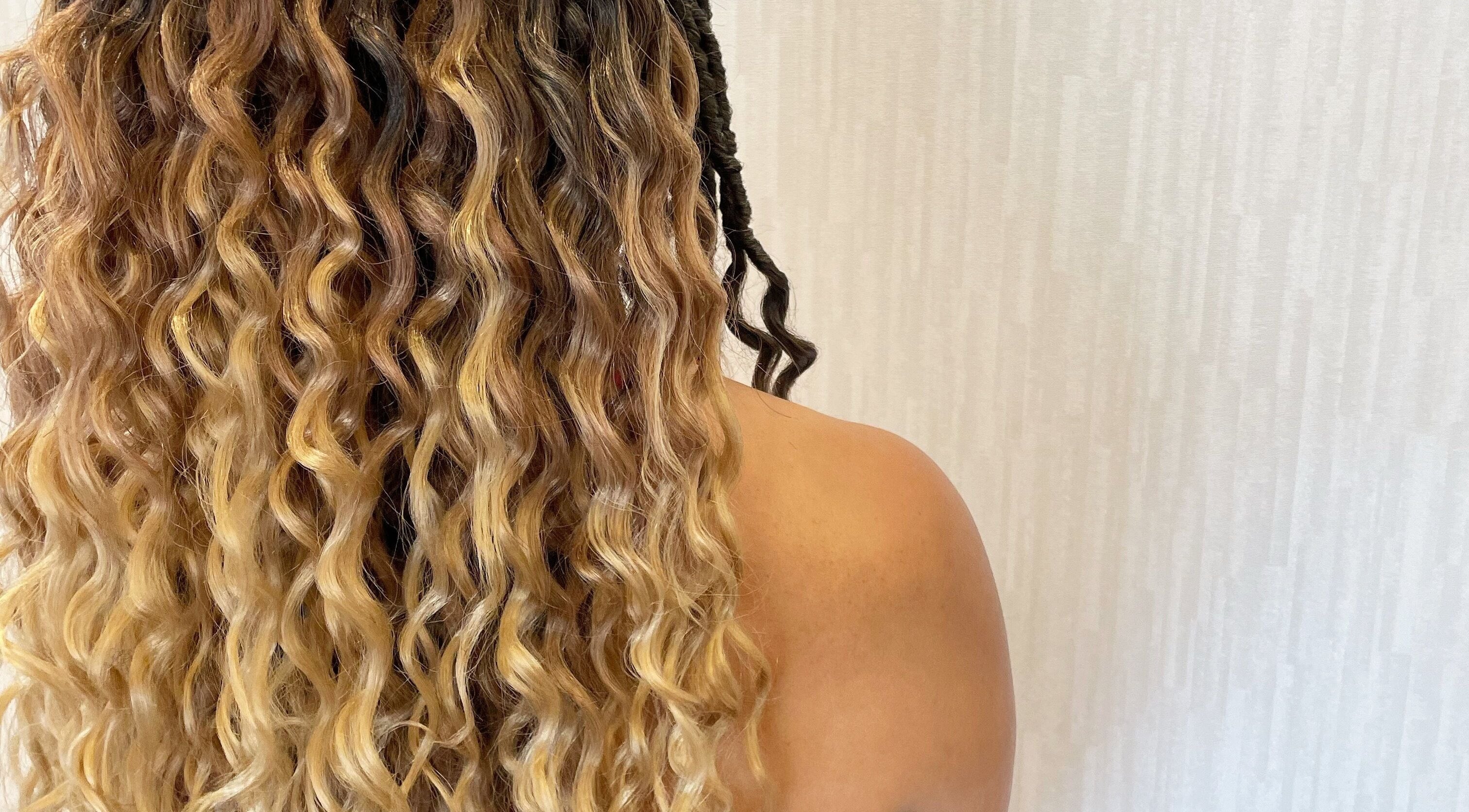 Curly hair transformation at Studio 23 Luxe in Cranbury, New Jersey, US, highlighting soft golden waves and texture.