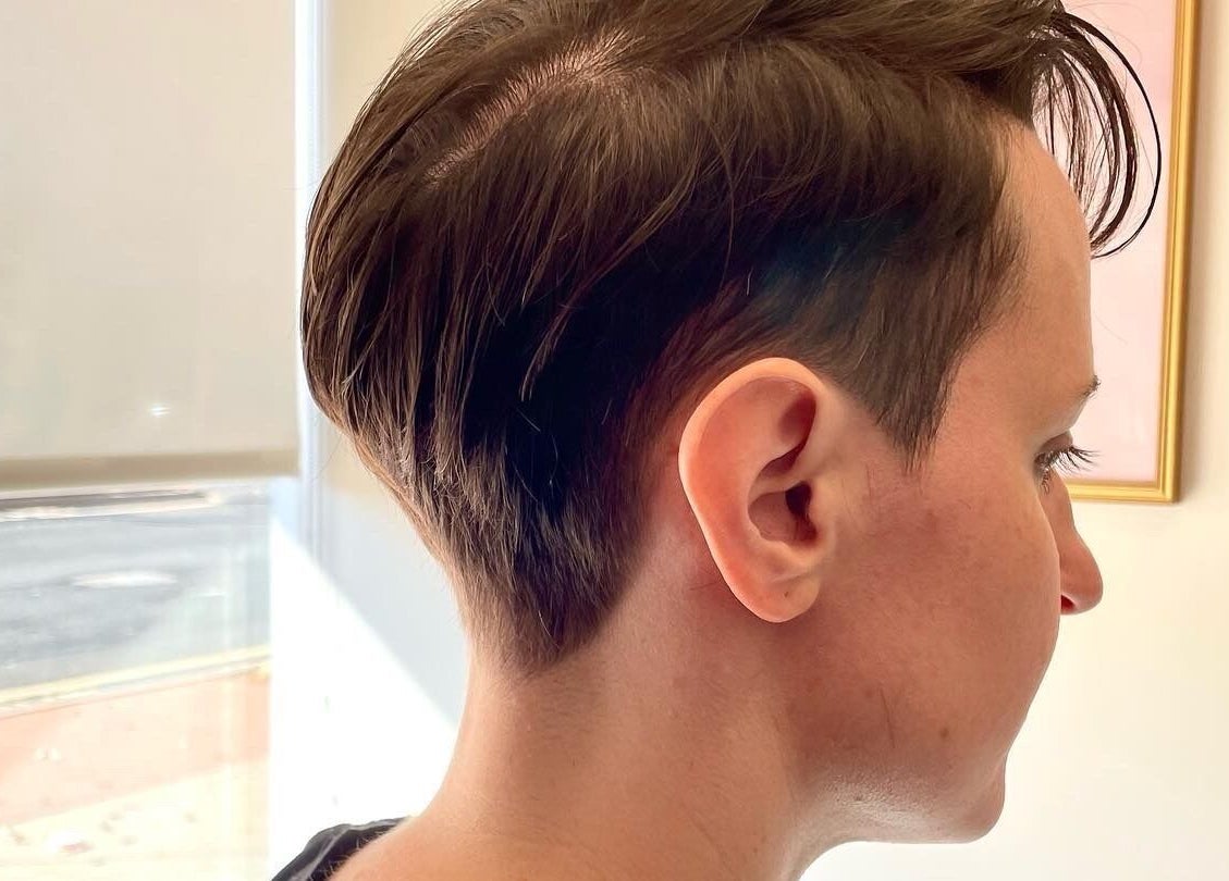 Side profile of a chic pixie cut at Studio 23 Luxe, Cranbury, New Jersey, US. Modern hairstyle in a bright salon.