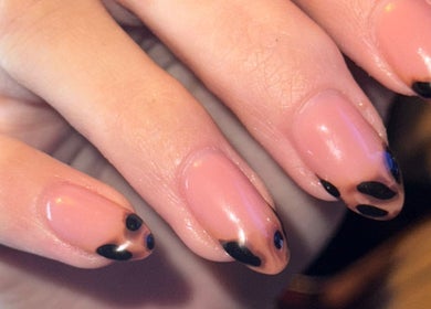 Close-up of elegant nail art at The Beauty Room, Seaford, England, GB showcasing black and nude polish.