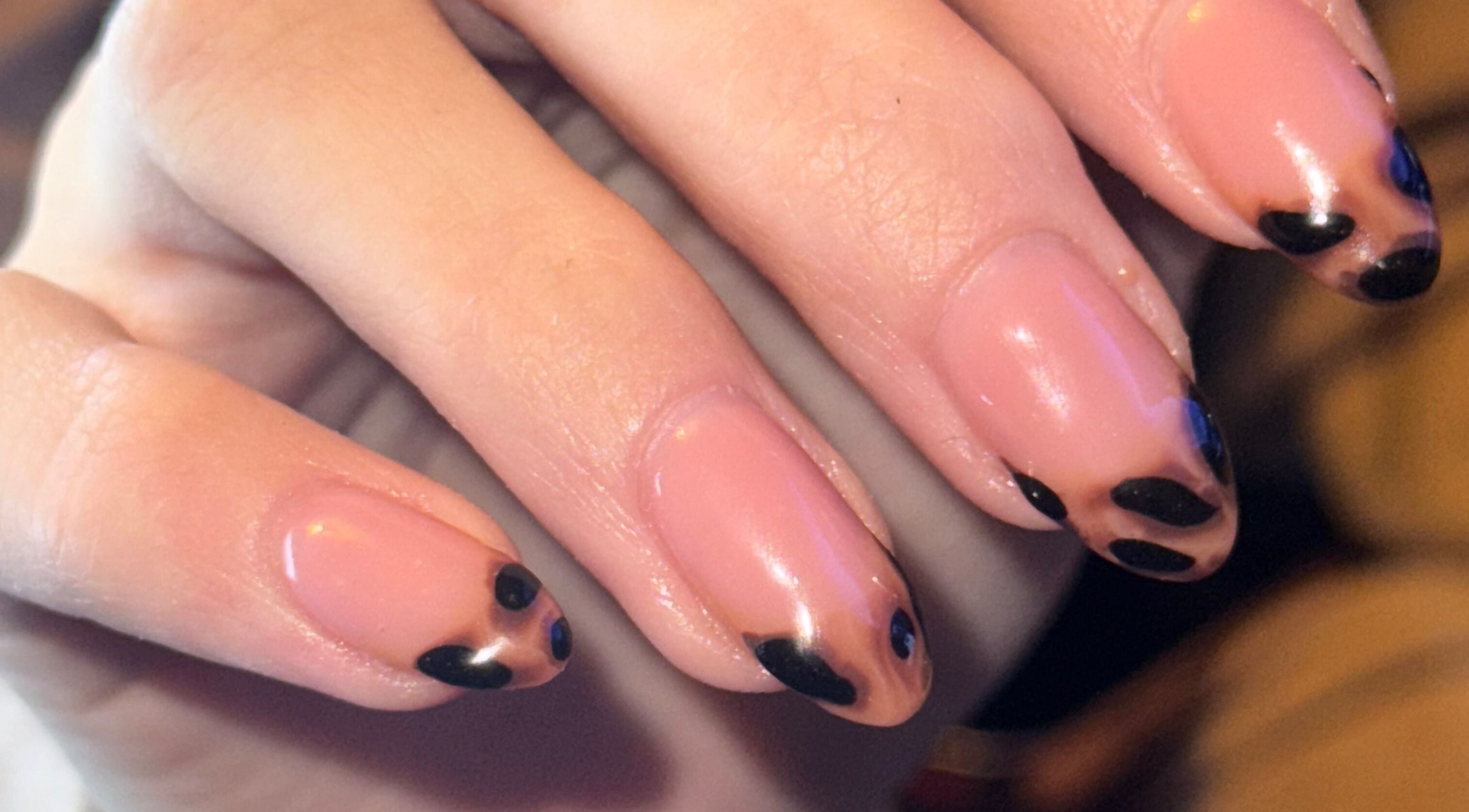 Close-up of elegant nail art at The Beauty Room, Seaford, England, GB showcasing black and nude polish.