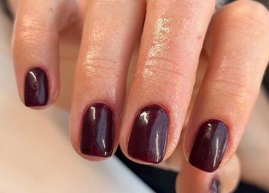 Shiny dark nails manicure at The Beauty Room, Seaford, England, GB.