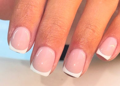 Stylish French manicure at The Beauty Room, Seaford, England, GB elegantly displays well-groomed nails.
