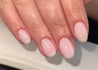 Glossy pink nails manicure at The Beauty Room, Seaford, England, GB, showcasing elegant nail art.