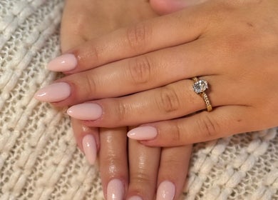 Manicured hands with a gold ring at The Beauty Room, Seaford, England, GB. Perfect for enhancing elegance.