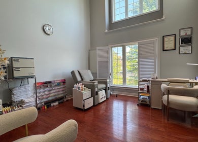 Serene nail therapy room at JJ Nails Spa by Helen Nham, Whitby, Ontario, CA, with cozy seating and natural light.