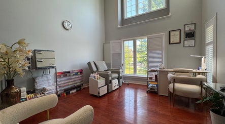 Serene nail therapy room at JJ Nails Spa by Helen Nham, Whitby, Ontario, CA, with cozy seating and natural light.