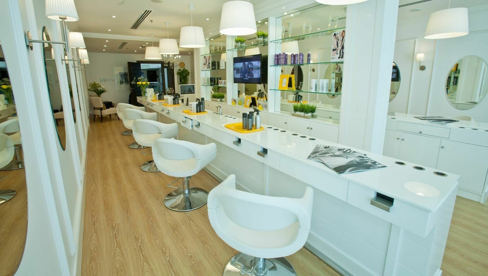 Bright interior of Blodry Bar Ladies Salon in Dubai, AE, showcasing modern styling stations and sleek decor.