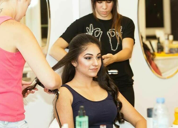 Stylists at Blodry Bar Ladies Salon, Dubai, AE, creating elegant hairstyle for a client in a chic setting.