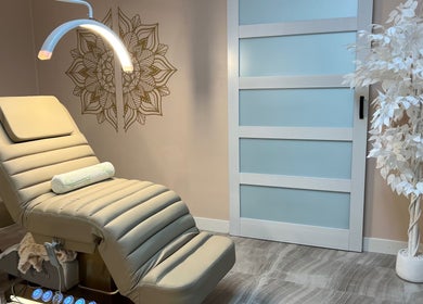 Relaxing treatment room at AvaBellas Brow & Skincare Studio, Bonney Lake, Washington, US with a beige therapy chair.