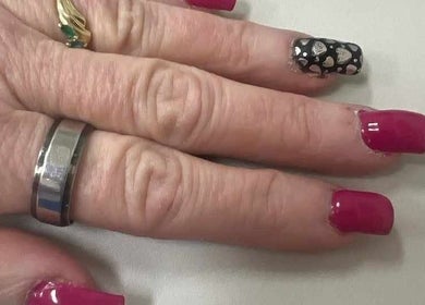 Elegant nail art at Be*Spelled Nails in Monte Vista, Colorado, US featuring pink and black heart designs.