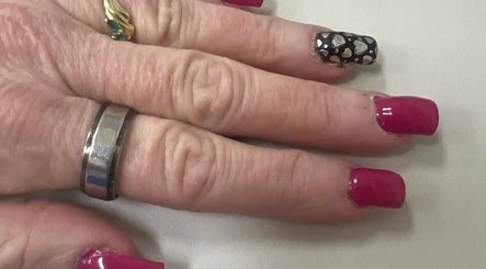 Elegant nail art at Be*Spelled Nails in Monte Vista, Colorado, US featuring pink and black heart designs.