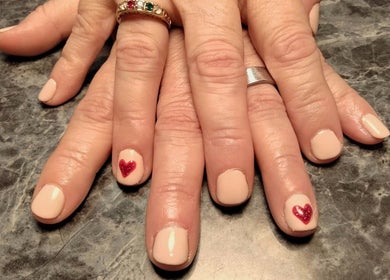Beautiful heart nail art at Be*Spelled Nails, Monte Vista, Colorado, US. Elegant nail design with red hearts.