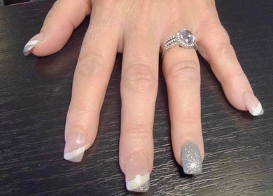 Stylish nail art with glitter at Be*Spelled Nails, Monte Vista, Colorado, US. A perfect example of nail craftsmanship.