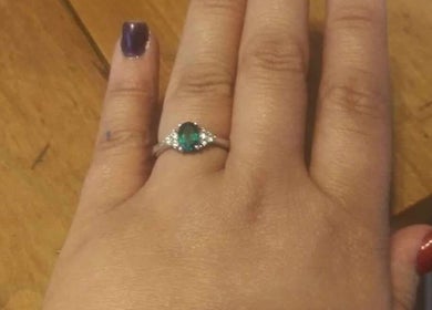 Hand with emerald ring and polished nails, showcased at Be*Spelled Nails, Monte Vista, Colorado, US.