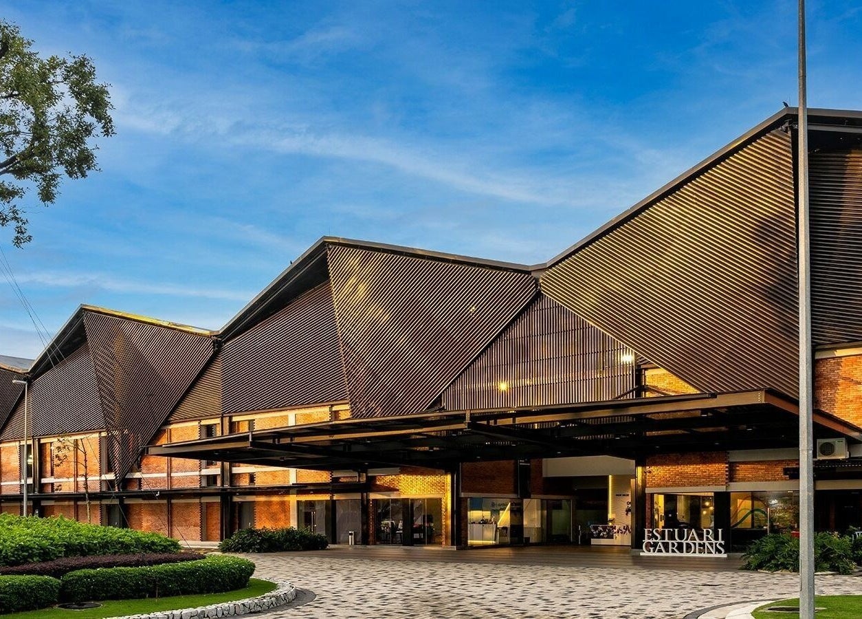 Modern exterior of Estuari Sports Complex in Iskandar Puteri, Johor, MY under a clear blue sky.