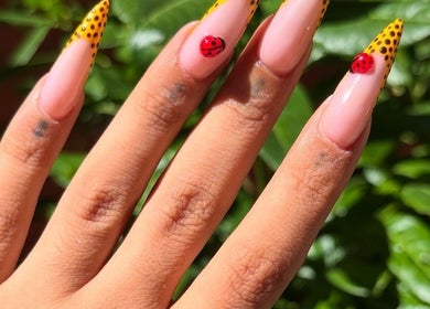 Stylish nail art with ladybird design at Nailed by Hay, London, England, GB.