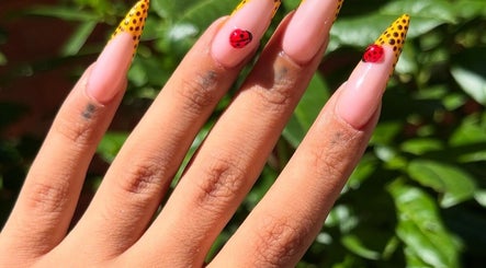 Stylish nail art with ladybird design at Nailed by Hay, London, England, GB.