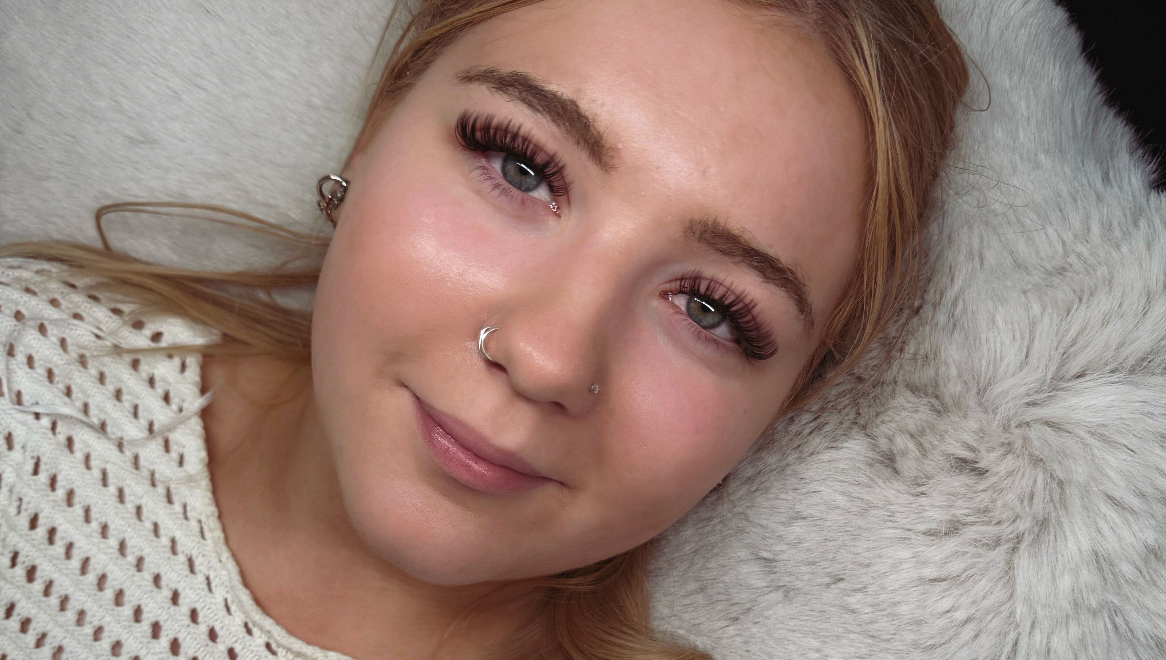 Woman with lush eyelashes at Lashed Up, Swindon, England, GB showcasing beauty treatment results.