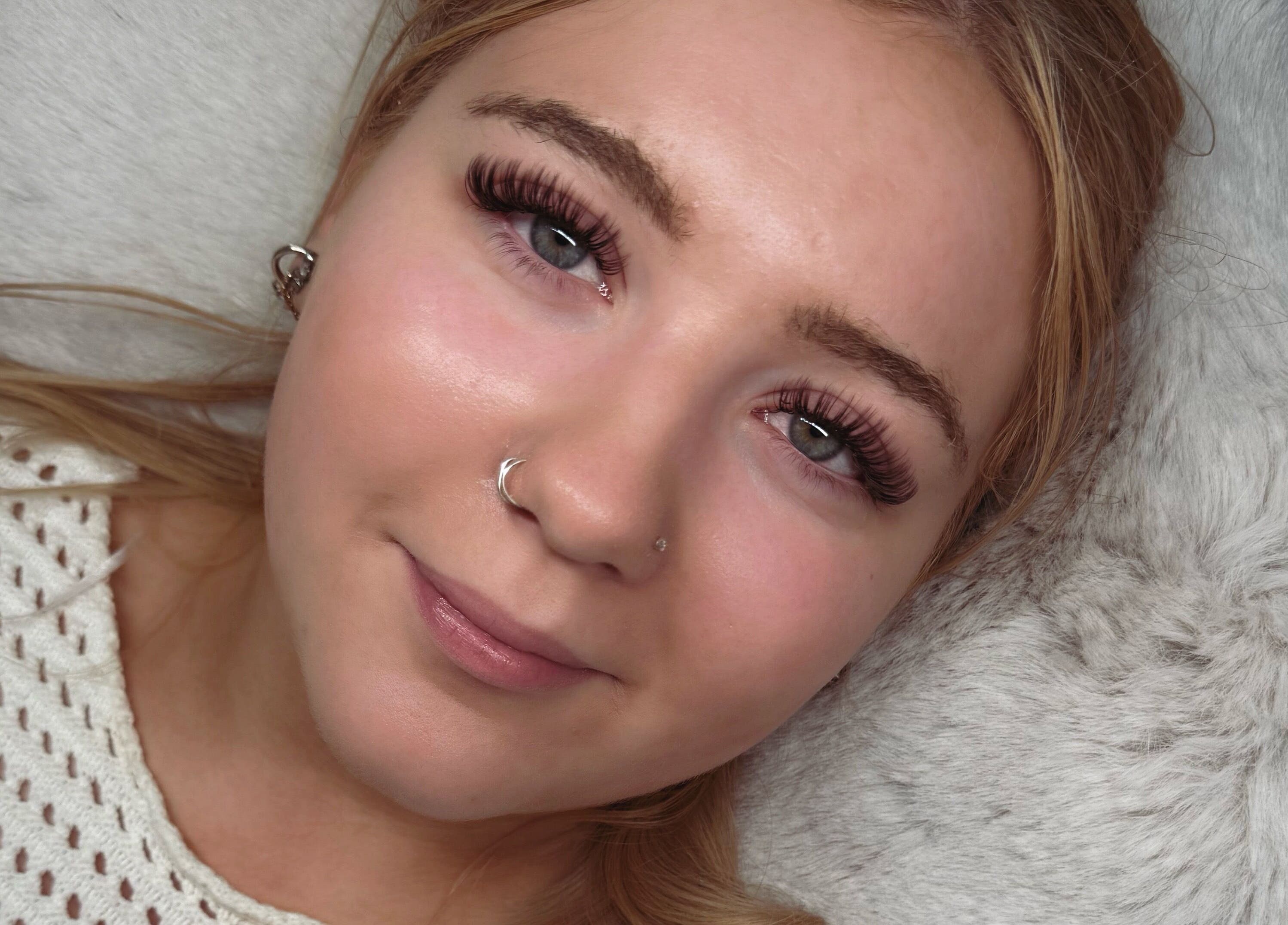 Woman with lush eyelashes at Lashed Up, Swindon, England, GB showcasing beauty treatment results.