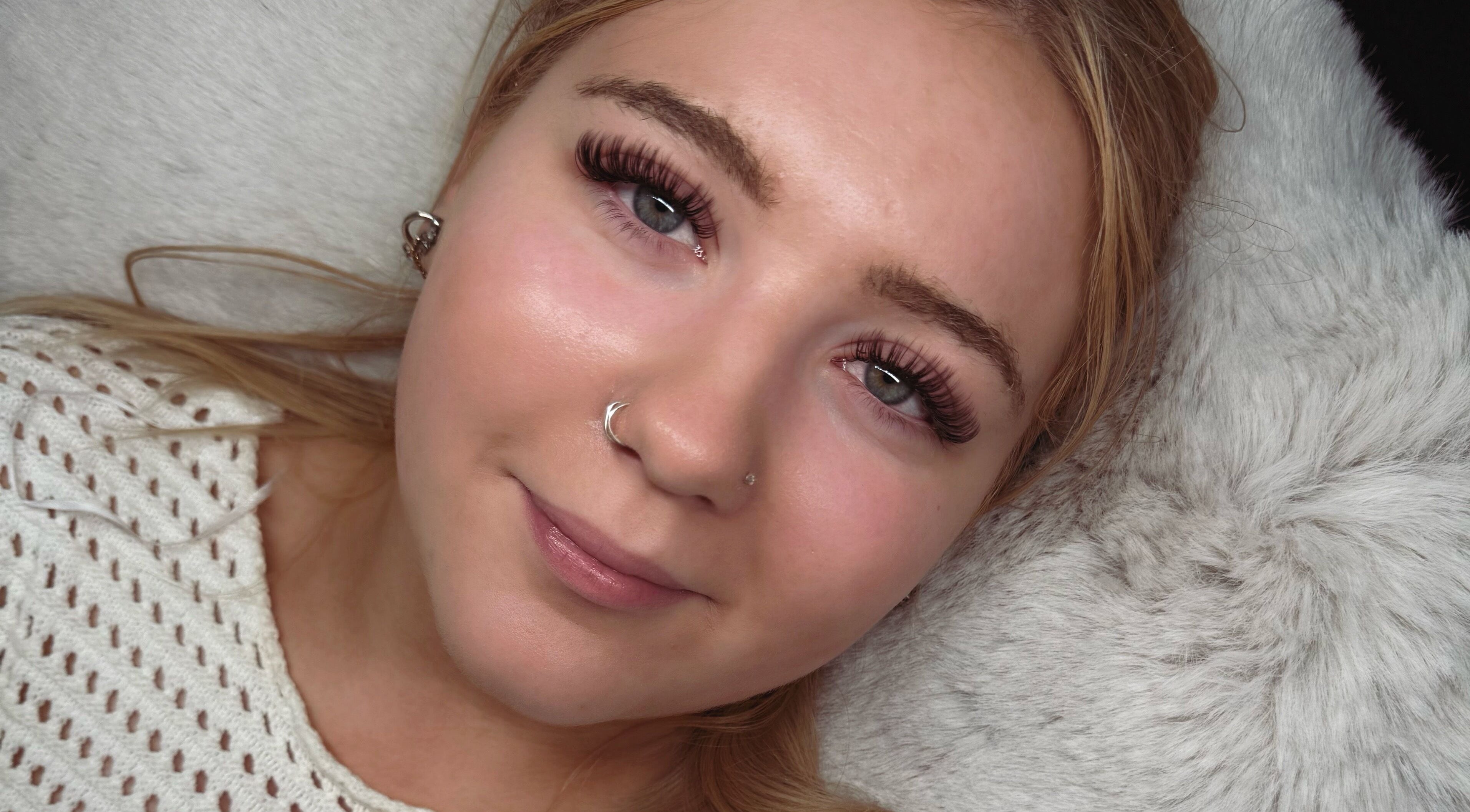 Woman with lush eyelashes at Lashed Up, Swindon, England, GB showcasing beauty treatment results.