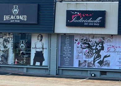 Exterior of INDIVIDUELLE SKIN & BODY in Durban, Kwazulu-natal, ZA showcasing stylish signage and neighboring shops.
