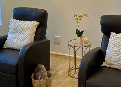 Relaxing lounge area at Orchid Aesthetics ZA in Cape Town, Western Cape, ZA with plush chairs and decor.